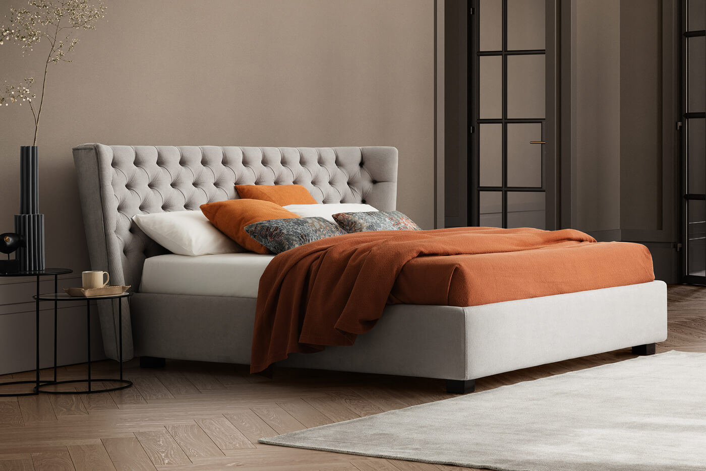 Letto elegante con testiera imbottita in tessuto grigio con motivo capitonnè