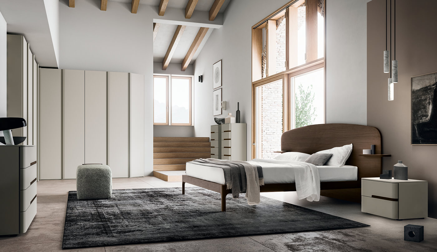 Camera matrimoniale con letto in legno scuro e armadio angolare moderno beige
