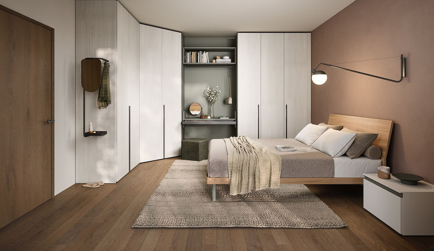Camera matrimoniale completa con letto in legno chiaro e armadio angolare moderno in legno bianco con scrivania integrata